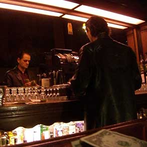 The owner of Toscas cashes out the register for the night